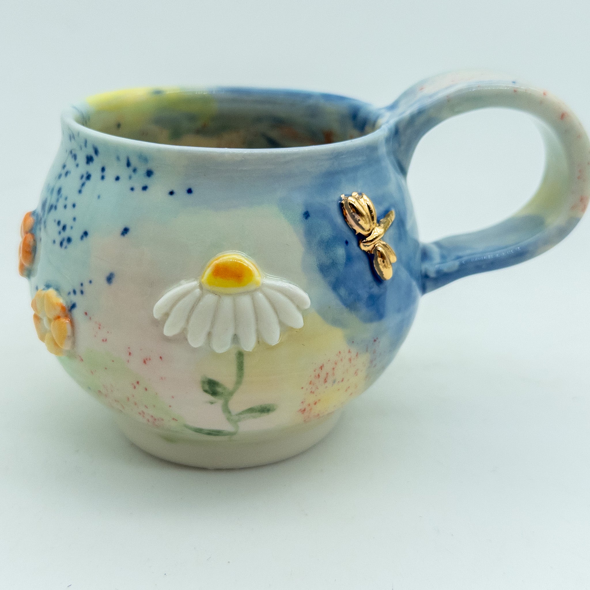 Kop med blomster og insekter